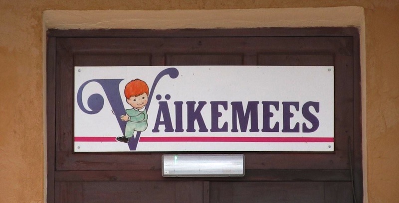 Seen on a street in the north-eastern Estonian city of Kohtla-Järve. What could be behind a door with a sign above it reading Väikemees (Little Man)? The building is surrounded by an enclosed yard and has playground equipment in the back. My first thought: "Could this be a private boys kindergarten?" Photo: Riina Kindlam