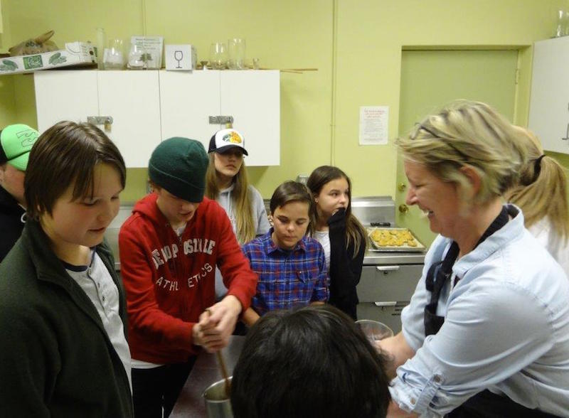 Susi Holmberg cooking with students at Estonian House kitchen - photo by Kai Kiilaspea (2015)