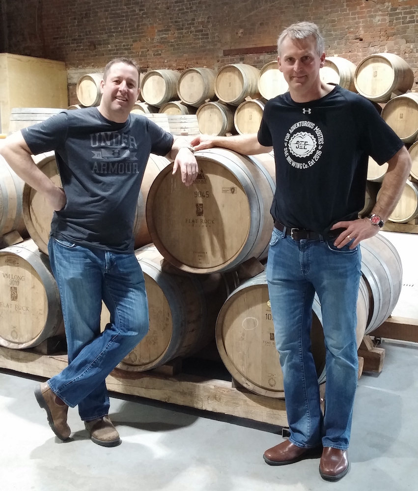 Co-owners Ed Madronich and Shawn Till with the oaken barrels where their beer is aging. Photo: Merike Koger