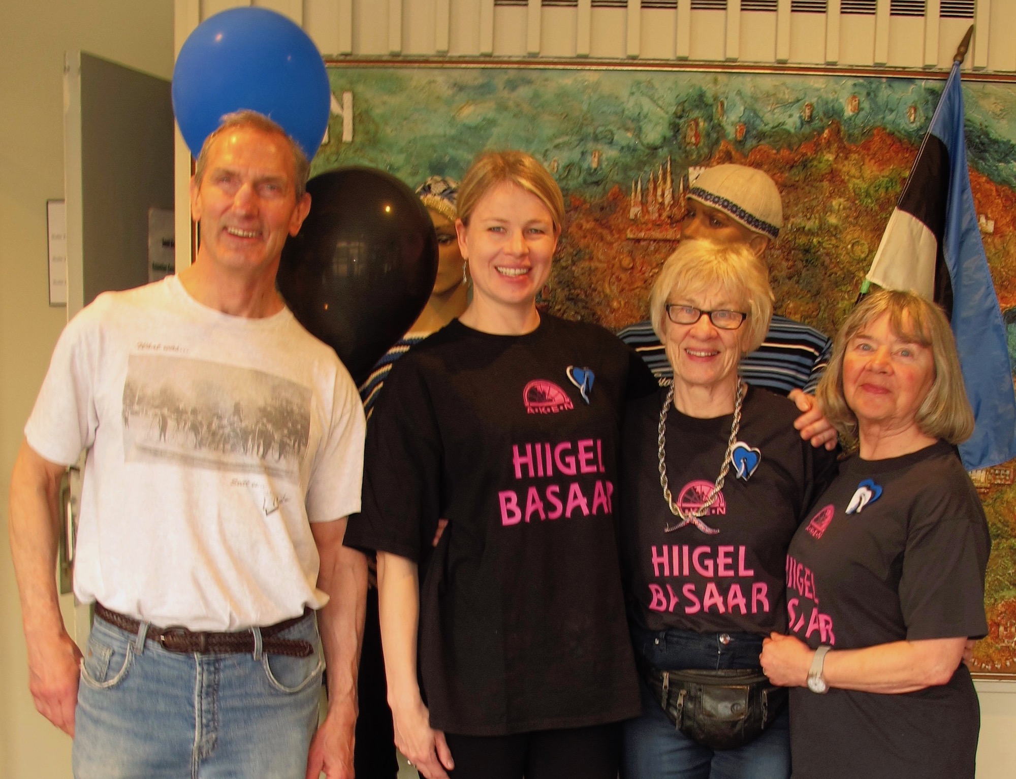 Lembi Veskimets (2nd from left) traveled furthest (Cleveland, Ohio), Gary Kirchner and Hille Viires (bookends) second furthest (Montreal) in order to help out Esto Boutique’s head honcho Rutt Veskimets at AKEN’s EV100 celebratory “BLUE-BLACK-WHITE” sales event on May 5th at Toronto Esto House.