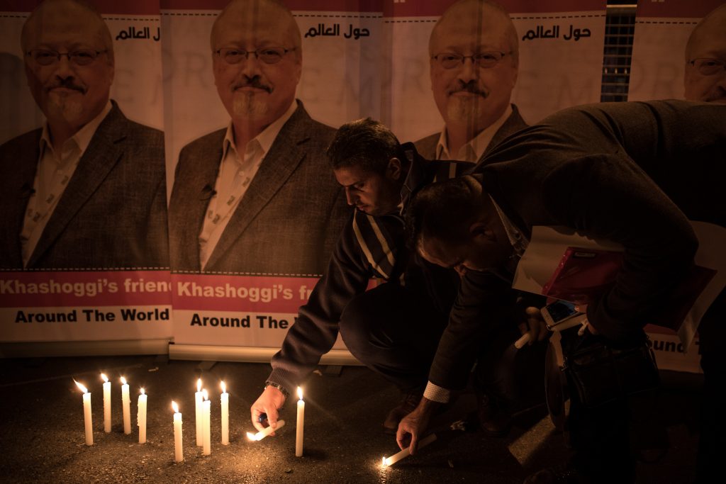 People light candles in front of posters of Jamal Khashoggi during a candle-light vigil to remember journalist Jamal Khashoggi outside the Saudi Arabia consulate on October 25, 2018 in Istanbul, Turkey. (Chris McGrath/Getty Images)