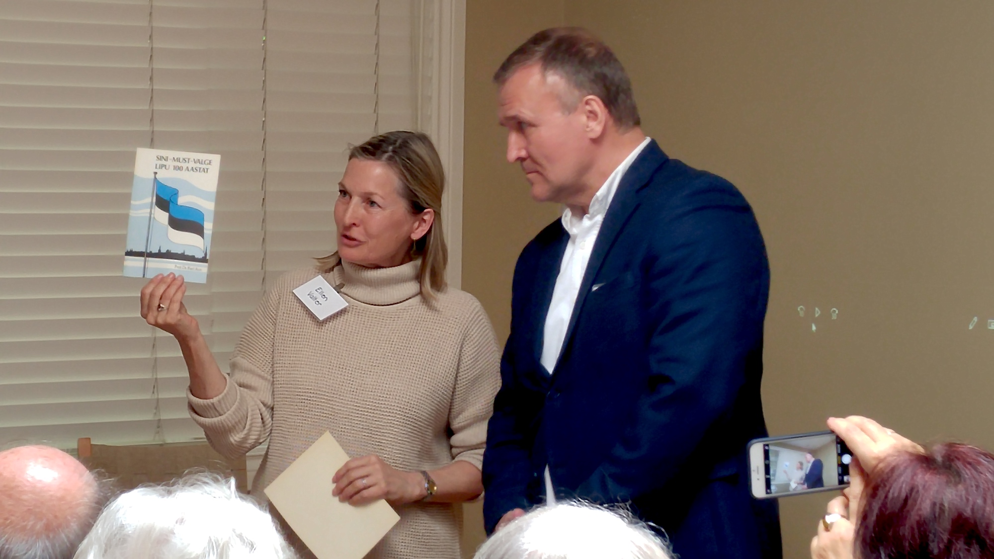 Celebrating Estonia's 135th Flag Day on June 2, Chair of International Estonian Centre, Ellen Valter (left), presents Estonian Ambassador to Canada, Toomas Lukk, with historic speeches published for the 75th and 100th Flag Day anniversaries for the Ottawa Embassy library once it has undergone its renovation.