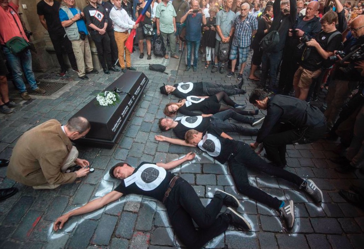 People lay on the pavement in front of the Czech Communist party headquarter as a symbol of the people who died 50 years ago during demonstration marking the first anniversary of the Soviet-led occupation, on Thursday in Prague. Some four thousend people gathered in Prague to protest against Czech Prime Minister Andrej Babis and Czech President Milos Zeman marking the 51th anniversary of the Soviet-led occupation. MICHAL CIZEK / AFP/GETTY IMAGES