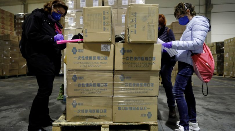 Workers sort out all the personal protective equipment (PPE) received from China at a warehouse in Valencia, Spain, on Mar. 25 2020. A total of 3,800,000 masks, 5,000 protective suits and 2,000,000 gloves arrived to Valencia region to equip hospitals and elderly homes. Photo: Juan Carlos Cardenas/EPA/CP