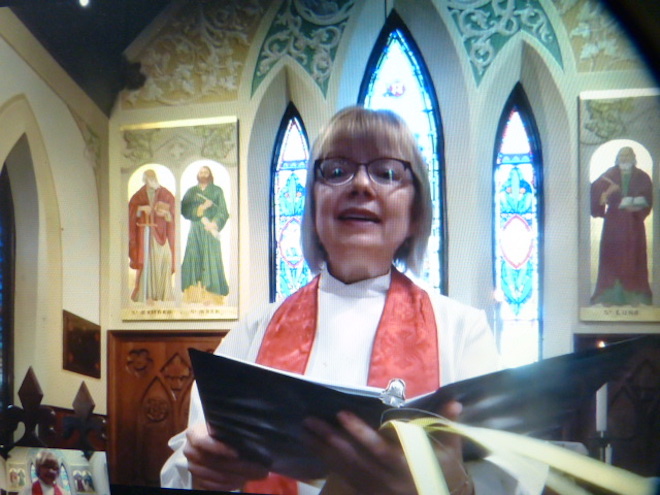 Rev. Lynn Mitchell, Incumbent, Priest and Pastor of the Anglican Churches of Quinte West, holding palm leaves in her hand, is seen addressing viewers from St. George's Anglican Church in Trenton for the Palm Sunday service. Two previous services were recorded from Holy Trinity in Frankford and Christ Church in Glen Miller. As a result, she has recently performed three complete services on youtube. These have included hymns rendered by her beautiful singing voice, for which she has provided her own accompaniment on organ and piano. Photo taken directly from computer screen by Andres Raudsepp