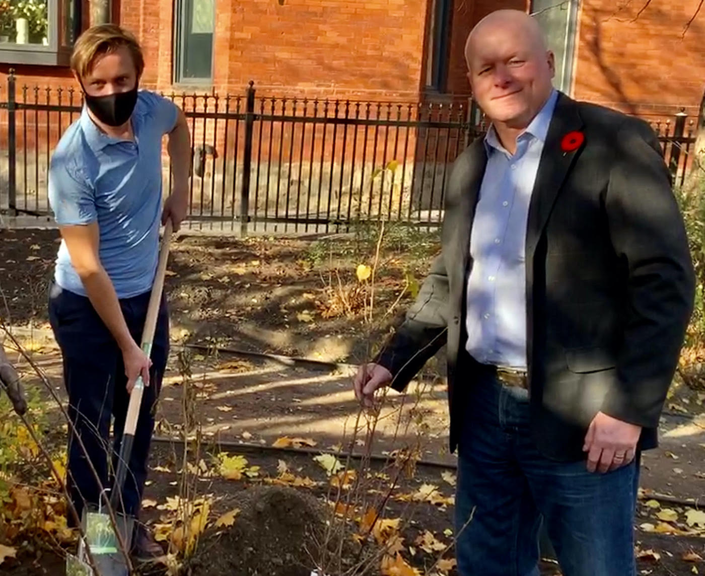 Veiko Parming, President of Estonian House and Chair of International Estonian Centre, left, and David Kalm, IEC Project Manager, right, planting the birch trees.
