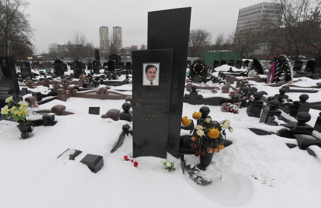 A picture taken on Dec. 7, 2012, shows snow clad grave of Russian lawyer Sergei Magnitsky with his portrait on the tomb (C) at the Preobrazhenskoye cemetery in Moscow. Magnitsky legislation “places responsibility for corruption and human rights abuse on individuals instead of punishing entire nations with broad sectoral sanctions,” writes Marcus Kolga. ANDREY SMIRNOV / AFP/GETTY IMAGES