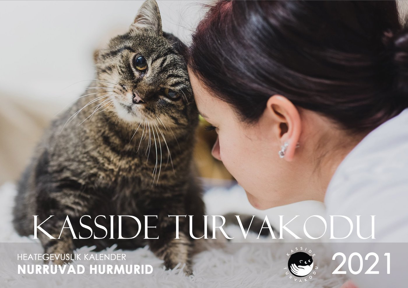 One of many fundraising *kalendrid* published by animal shelters (*loomade turva/kodud*) in Eesti. This one features whiskered *kaane/tüdruk* (cover girl) Maali. She is a *triibik* – with *triibud* (stripes), having the tabby stripe pattern coat type. Photo: www.kassideturvakodu.ee