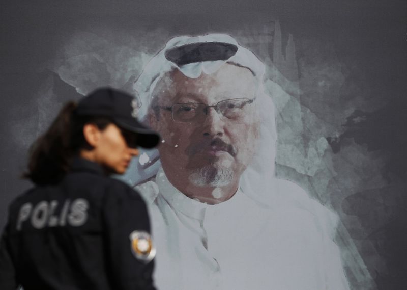 A Turkish police officer walks past a picture of slain Saudi journalist Jamal Khashoggi prior to a ceremony, near the Saudi Arabia consulate in Istanbul, marking the one-year anniversary of his death. LEFTERIS PITARAKIS/THE ASSOCIATED PRESS via The Globe and Mail