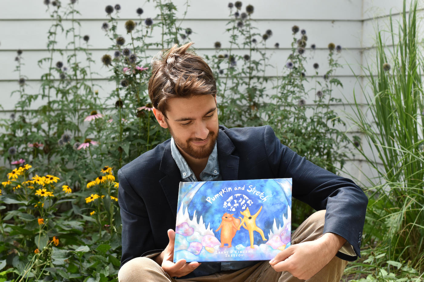 @vincentteetsov holding a copy of his book *Pumpkin and Stretch*