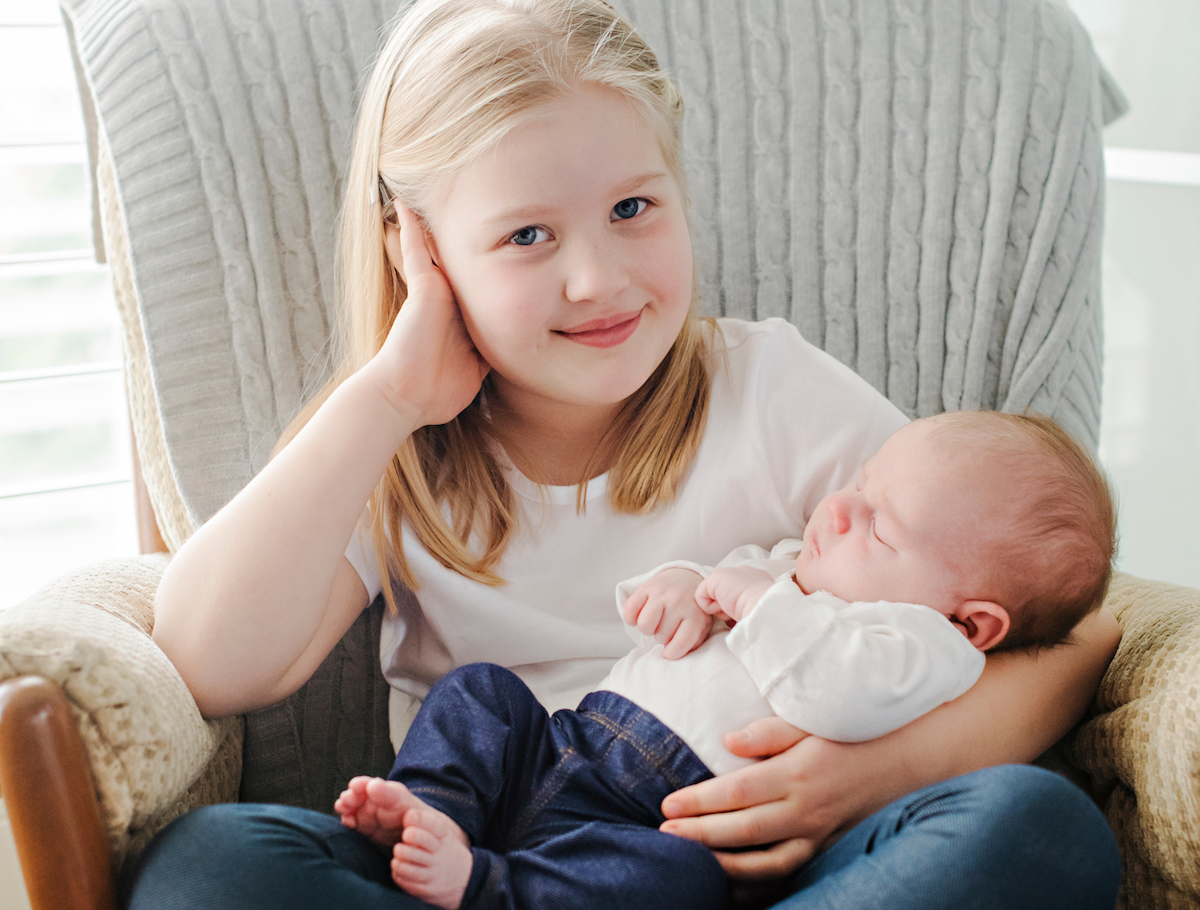 Maali holding her new little sister, Kaja