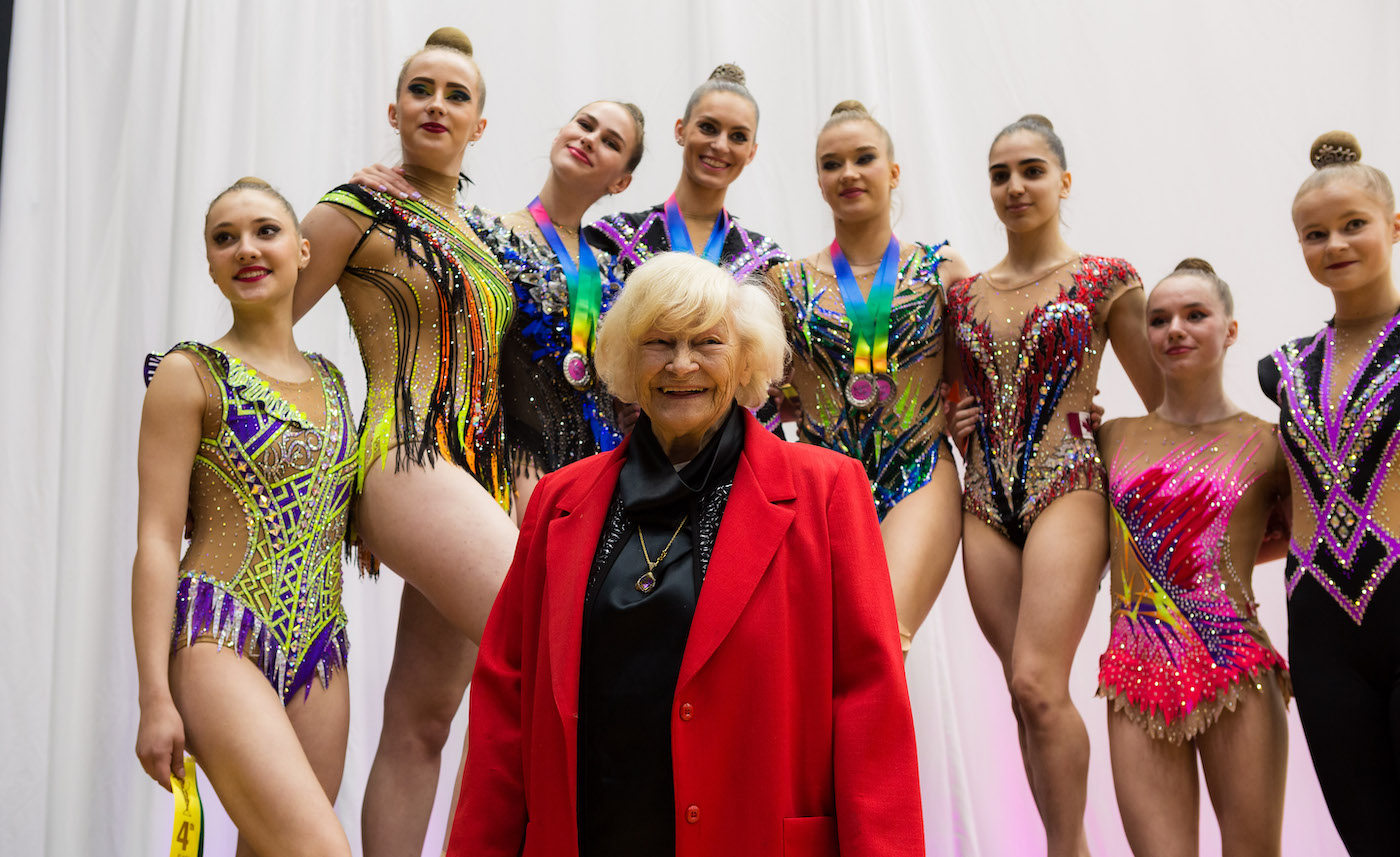 Evelyn Koop and the top 8 Senior High Performance All-Around gymnasts during the awards ceremony. Carmel Kallemaa, 4th from the left, won all-around Gold at the 2022 Koop Cup Competition. Photo by Tommy Ray Loite