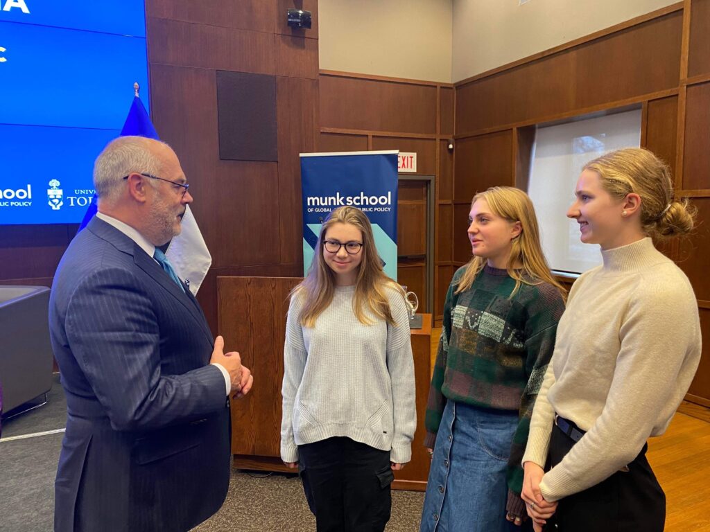 Estonian President Alar Karis speaking with ESTA members Maiki Müürsepp, Kaisa Kasekamp, and Aleksa Gold