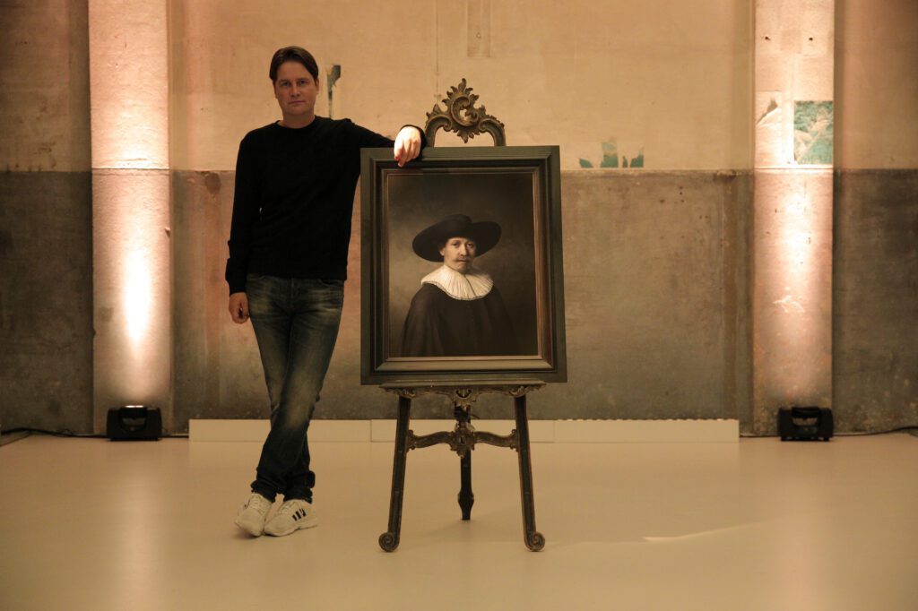 Executive creative director of the J. Walter Thompson Amsterdam agency, Bas Korsten, poses with the painting. Source: npr.org