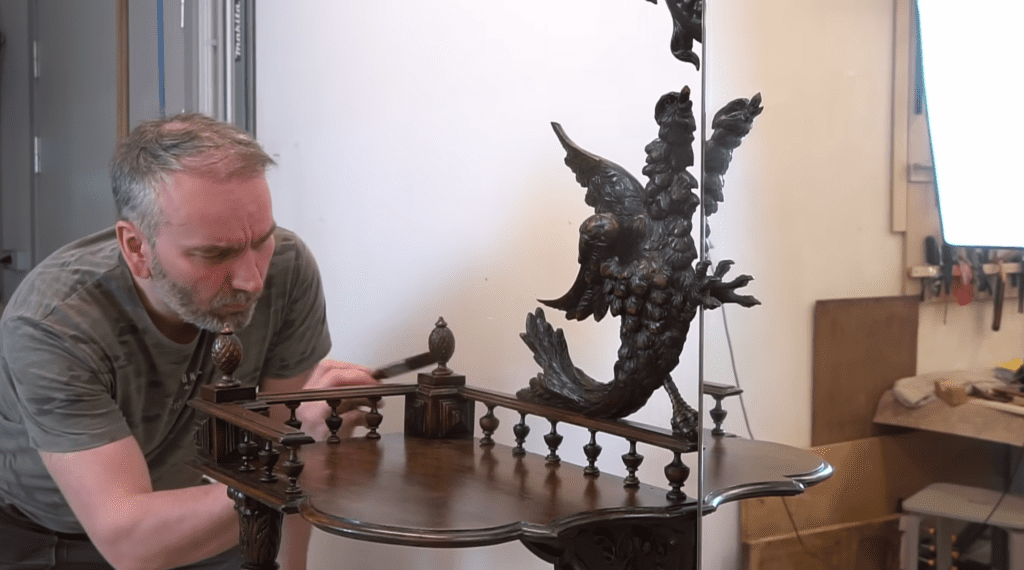 Ahti Toplaan applying the finishing touches to a vanity table he restored