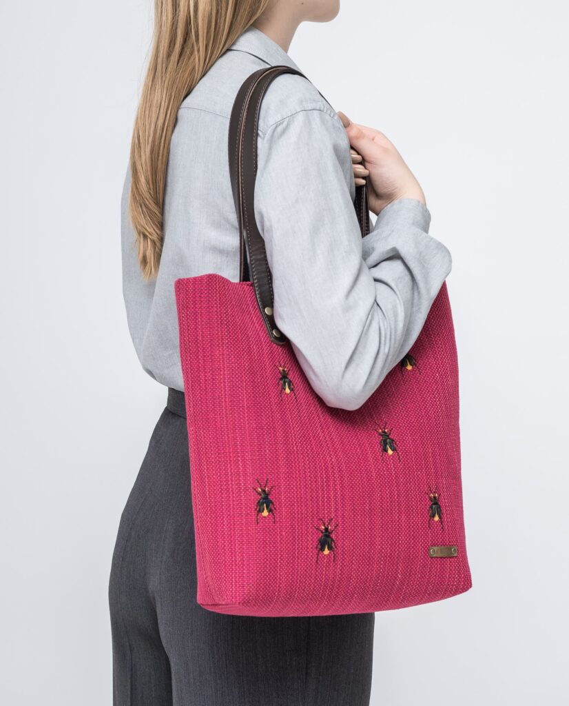 A pink bag with embroidered bugs (source: kangotextile.com)