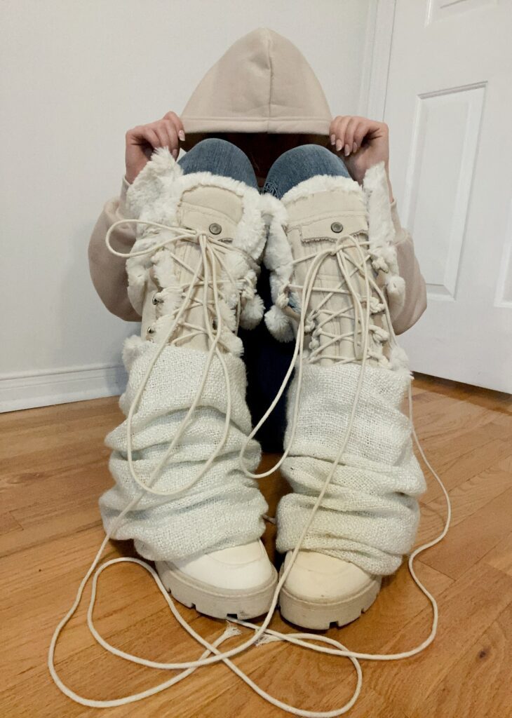 Kai notes “I thrifted a pair of ankle boots that were heavily stained and unsalvageable. I used additional fabrics from a jacket, blanket and pillow to construct them into knee high boots with leg warmer covers.”