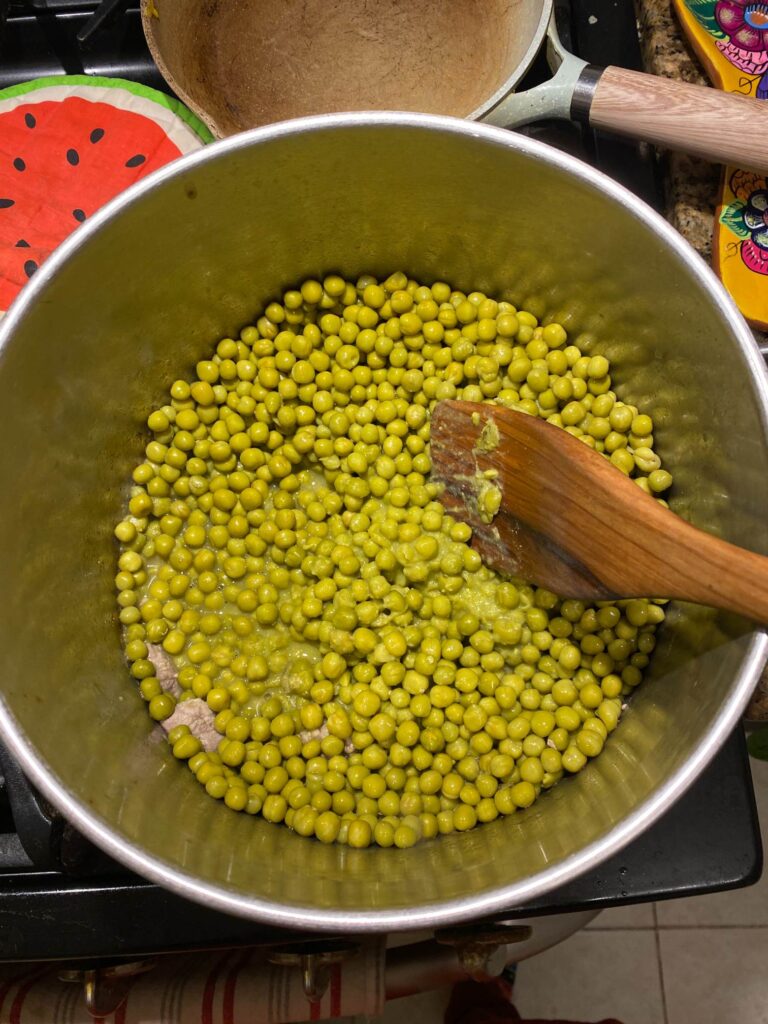 Adding the peas to the pork