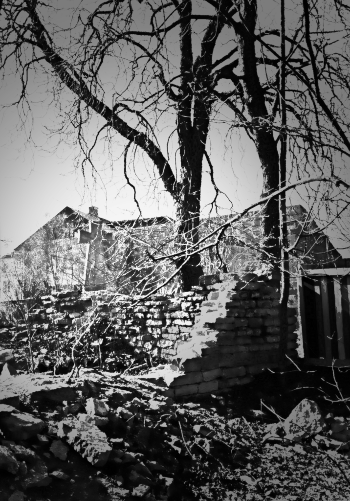 Seen through a broken wall, the Hochgreve cross stands amid quiet decay. Photo: Jerry Mercury
