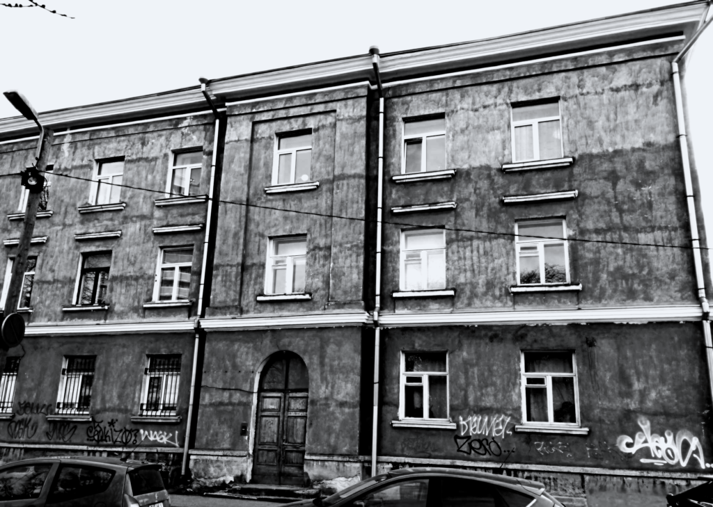 A Soviet apartment block from the early post-war years, opposite the Hochgreve cross on Marta Street. Graffiti tags mark the lower part of the façade. Photo: Jerry Mercury