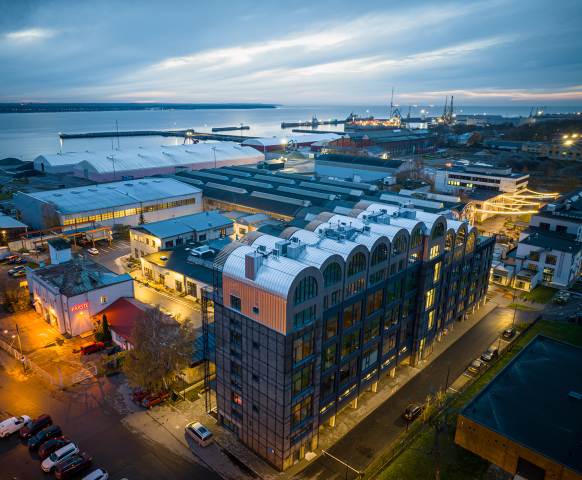 An aerial view of the new residential building with a hangar-inspired roof (photo: Riho Kirss)