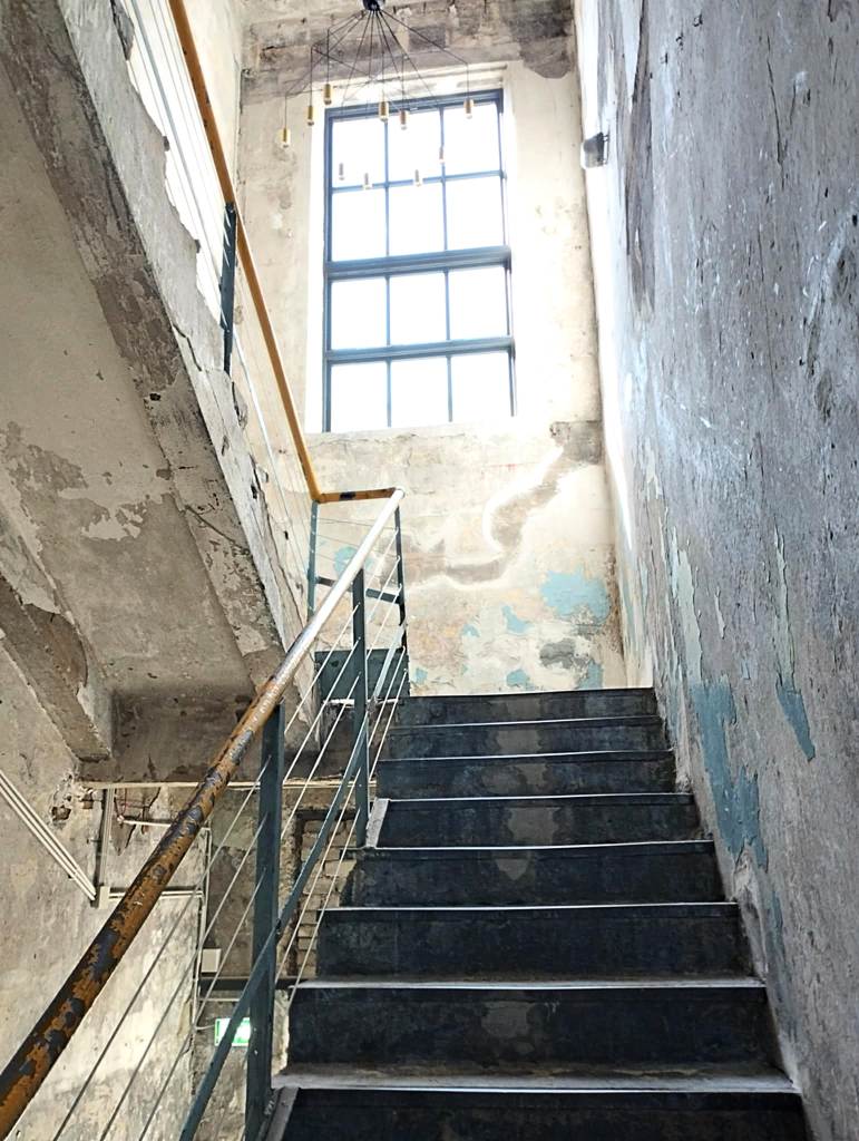 A stairwell at Põhjala Tehas; the original walls, with their worn paint, have been carefully preserved (photo: Jerry Mercury).
