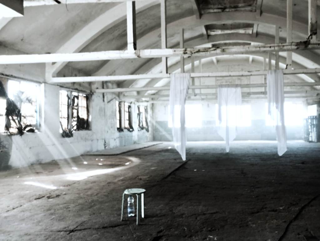 In the interior of the hangars at Põhjala Tehas, sunlight filters through the windows, casting long beams across the floor (photo: Jerry Mercury)