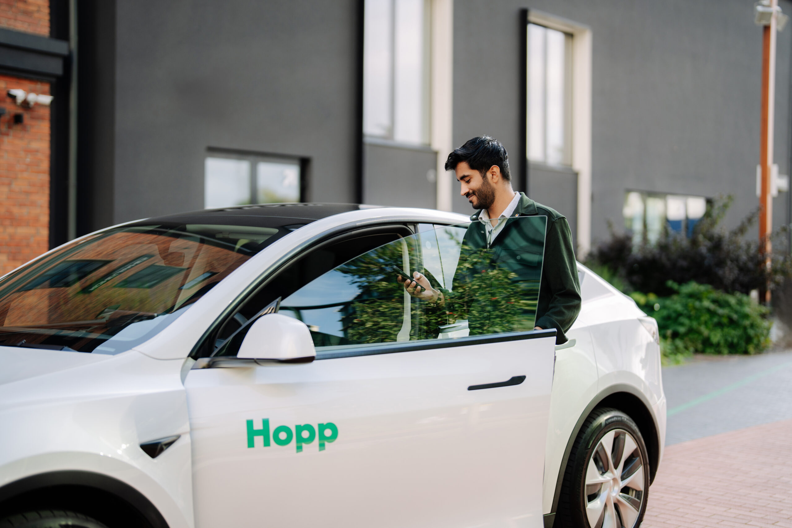 Hopp ridesharing app vehicle with a driver getting inside the car