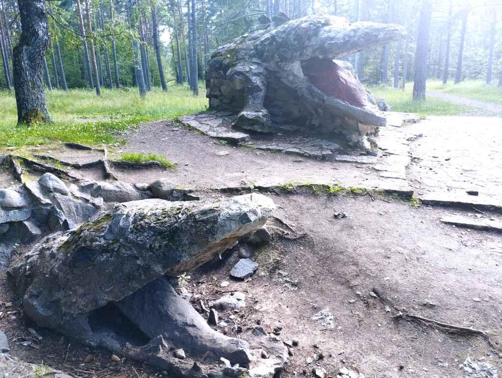 In the foreground is the dragon’s original head, half-buried in the ground. In the background is the full sculpture (photo: Jerry Mercury)