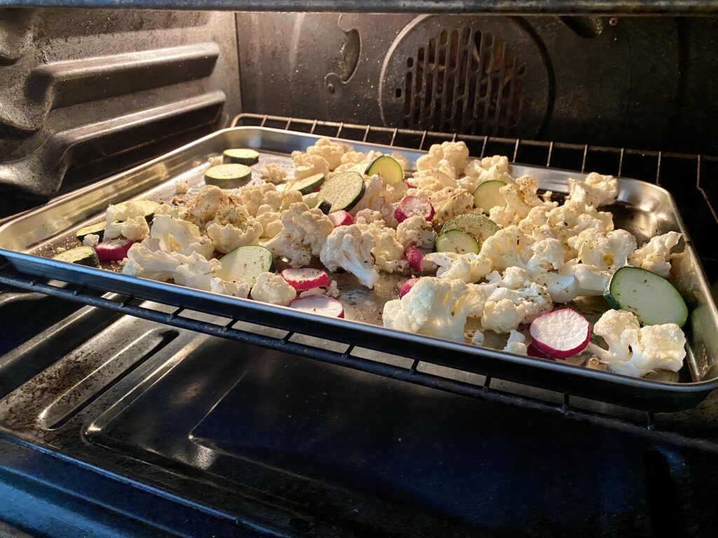 Roasting the cauliflower, zucchini, and radishes