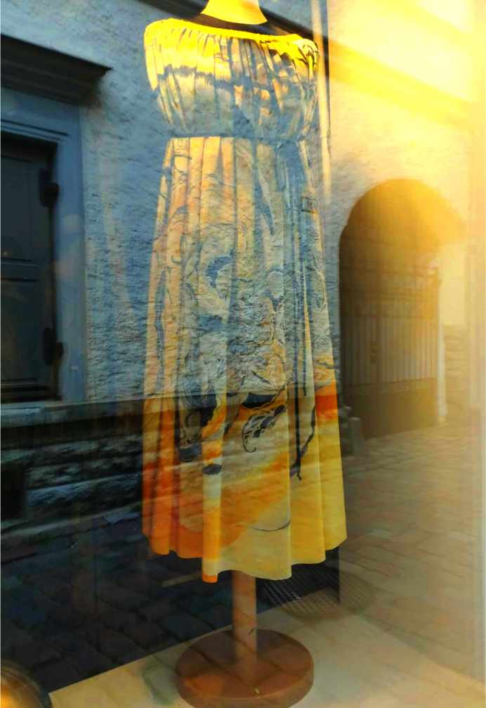 A silk dress by Maire Valdma in the atelier window, with reflections of Müürivahe Street behind it (photo: Jerry Mercury)