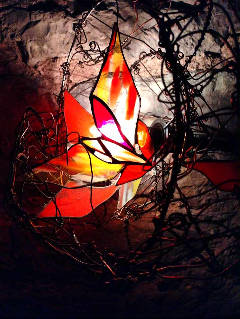 A stained-glass lamp by Maire Valdma, shaped like a fiery flower with sharp petals, in the second hall of Lummus (photo: Jerry Mercury)