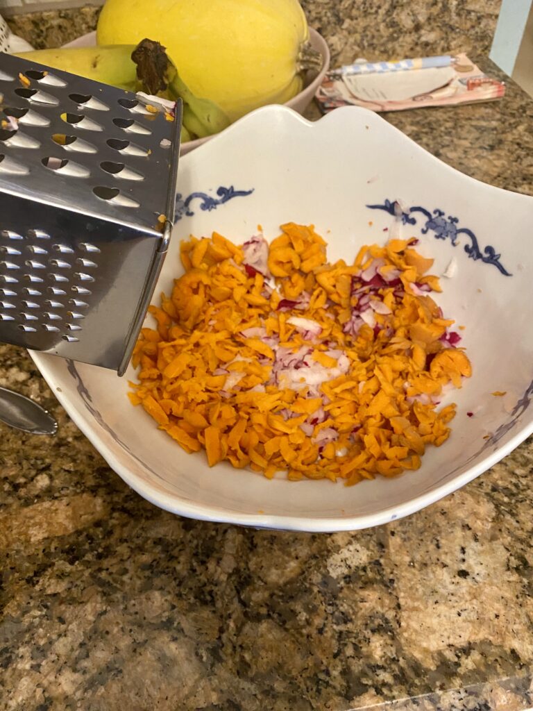 Grating the carrots and radishes for the coleslaw