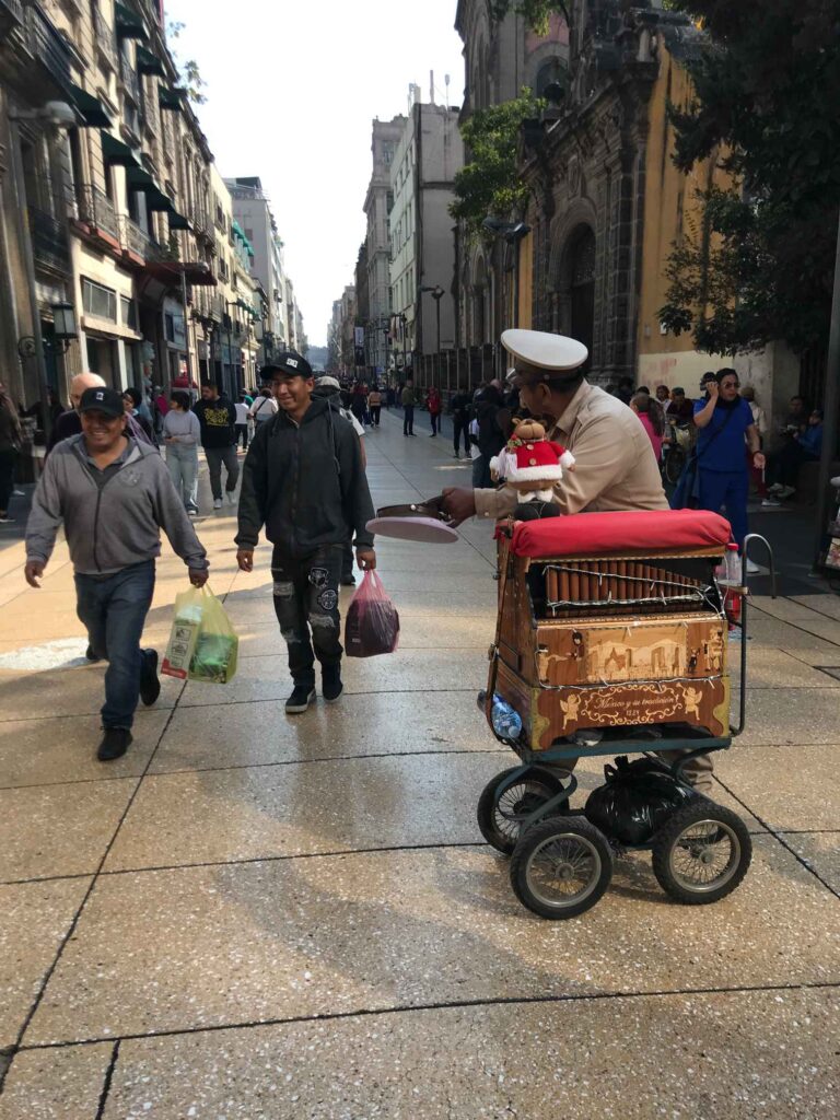 An organillero at work in the downtown core of CDMX