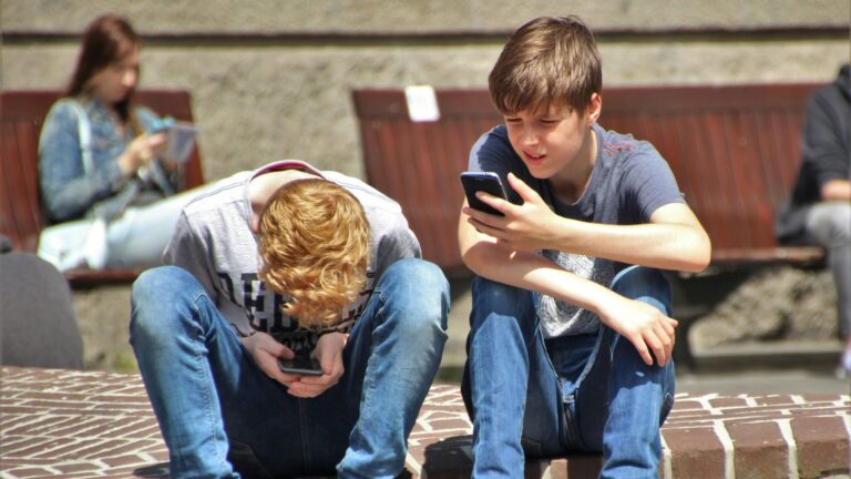 Two boys using their phones, from pexels.com
