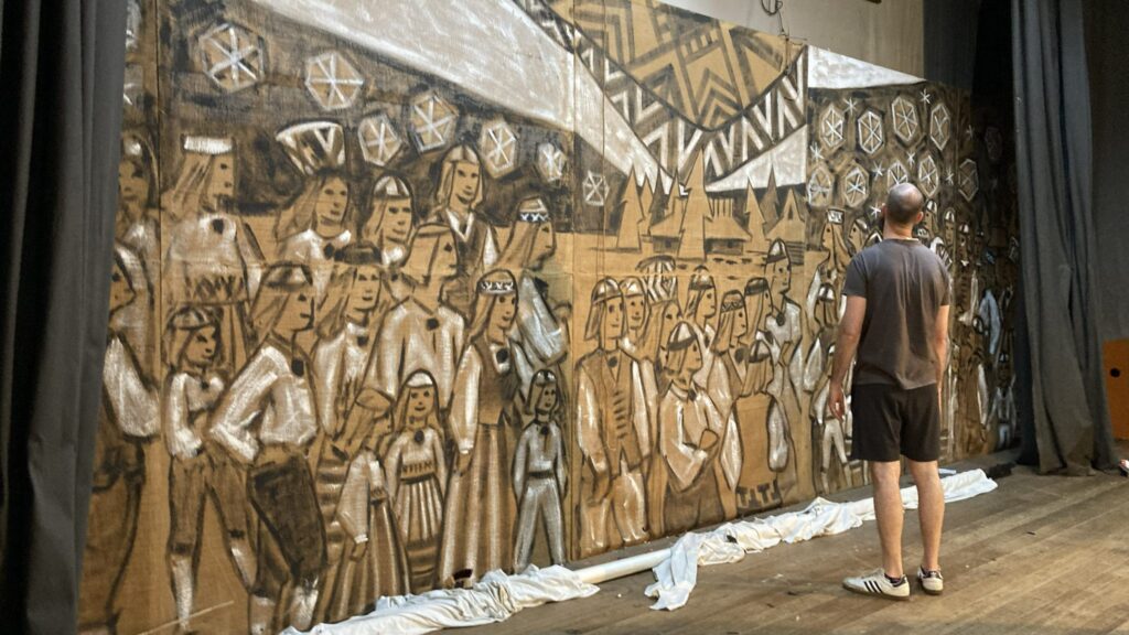 Folk dance teacher Rein Kiviväli studying the painting by Estonian Australian artist Gunnar Neeme at the Estonian House in Melbourne, December 2024