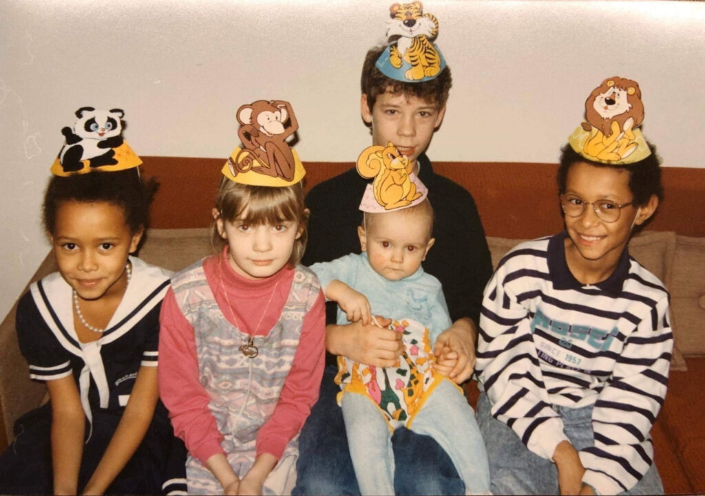 Photo of Jonas Tarm (third from left) at age one with Jim Ashilevi (far right, stripped shirt). Photo by Michael Tarm.
